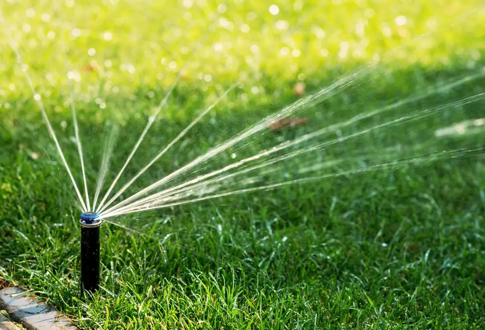 Automatic sprinkler system watering lawn