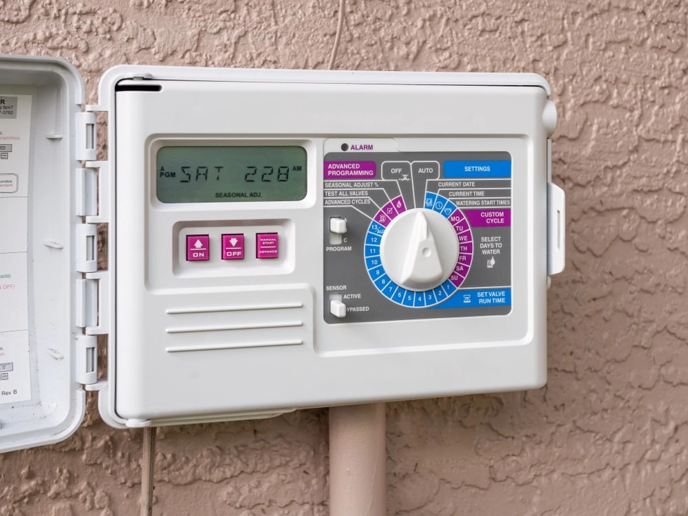 Sprinkler control system on the side of a home