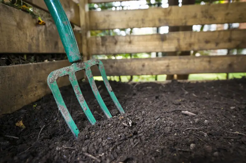 Pitchfork in compost for turning