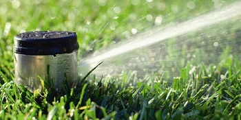Automatic sprinkler system watering lawn