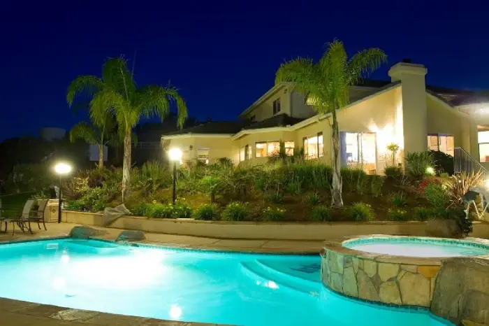 House backyard with landscape lighting installed by The Grounds Guys