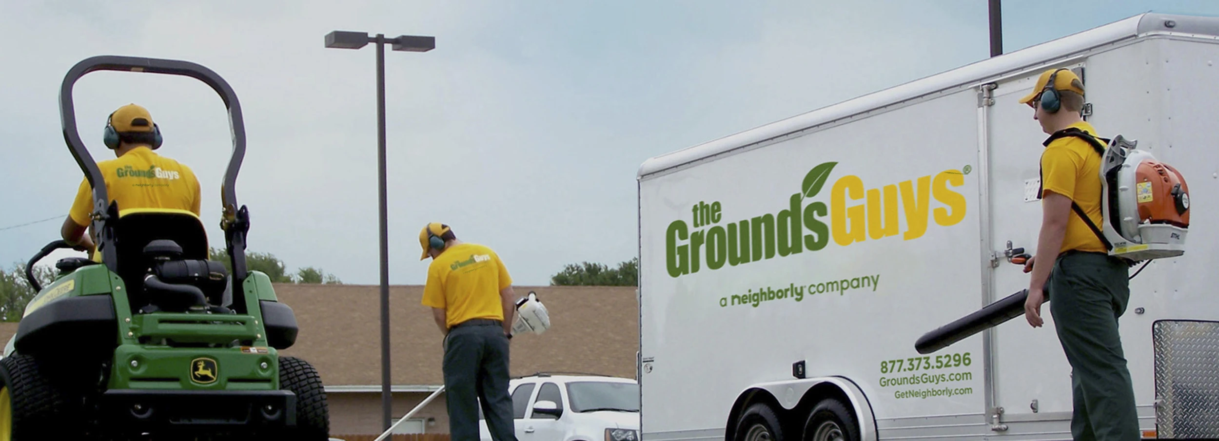 Grounds guys team with truck and equipment.