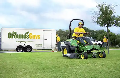 The Grounds Guys Working on Grass Cutting Machine at Memorial Park