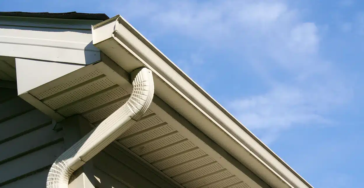 The gutters, downspout, and eaves of a home.