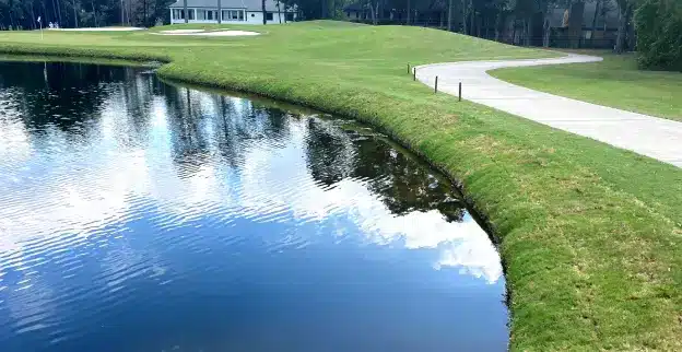 A pond on a golf course, with its shoreline reinforced by ShoreSOX solutions.