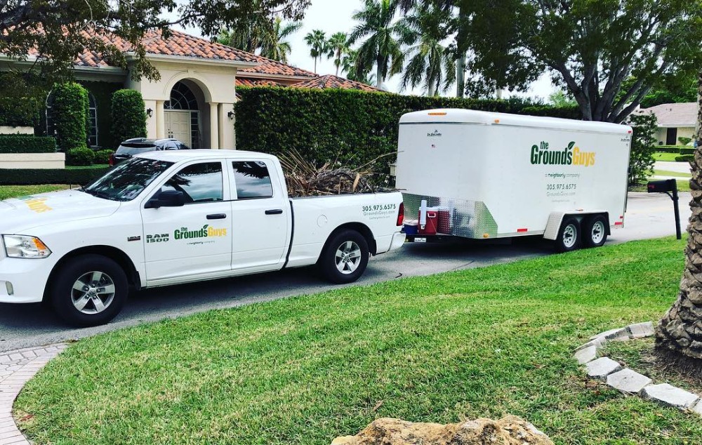 A truck with a trailer parked in the driveway
