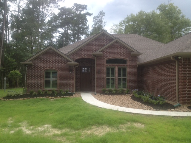 Front of brick house with grass yard