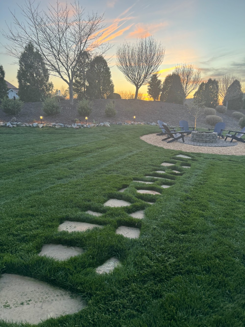 Maintenance customer requested a slate pathway from their deck to a brand new (built by The Grounds Guys) outdoor fire-pit with circular paver base and thick river rock border.