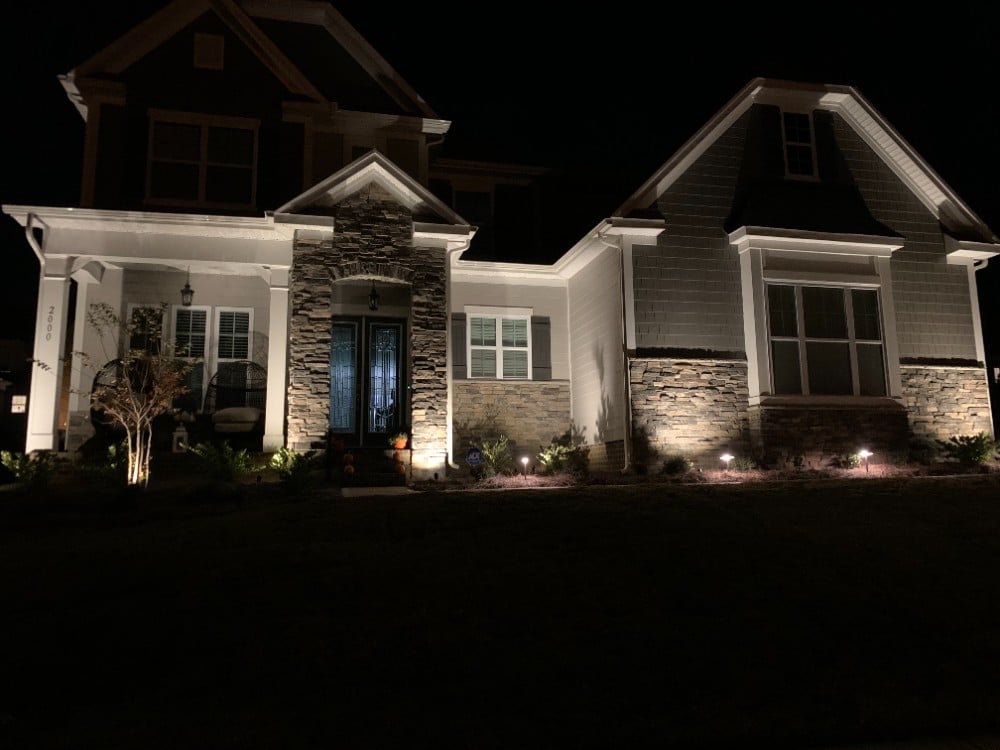 Bright white landscape and pathway lights create the perfect soft highlight to the front of a beautiful home.