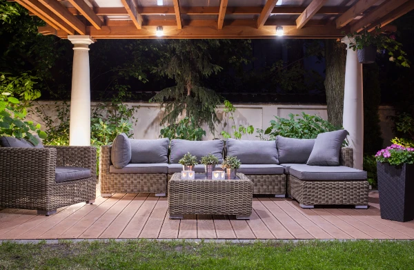 Outdoor lighting over patio area with sectional couch