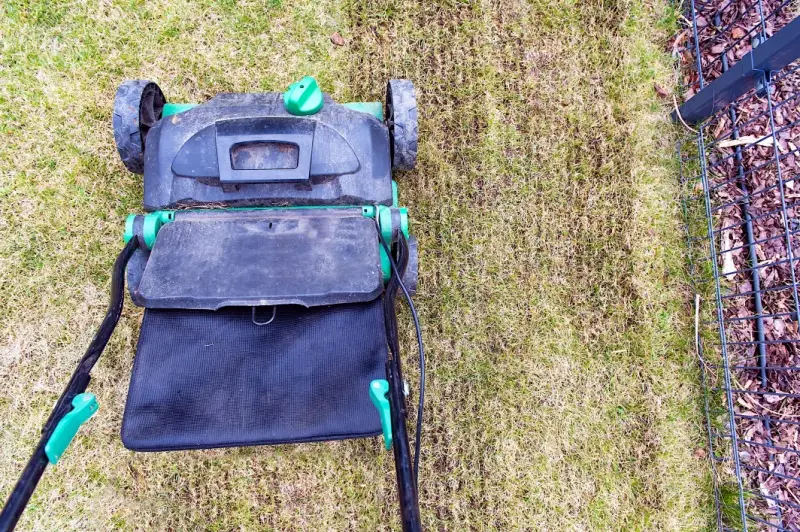 Overhead view of a lawn aeration machine on grass.