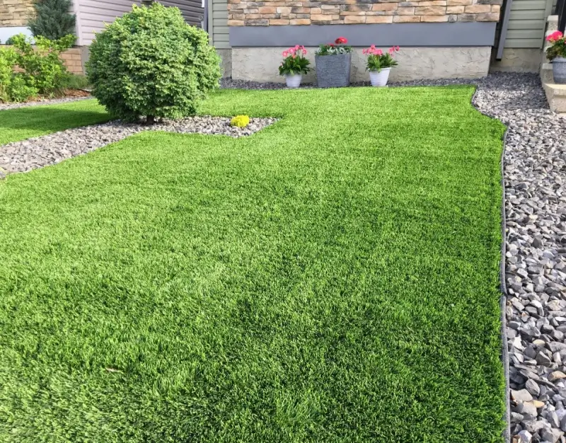 Residential landscape with artificial turf. 