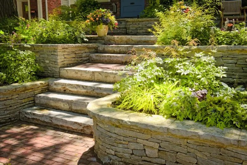 Entry way of a home with plants and stone steps.