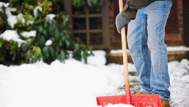 Man shoveling snow | The Grounds Guys of Gettysburg