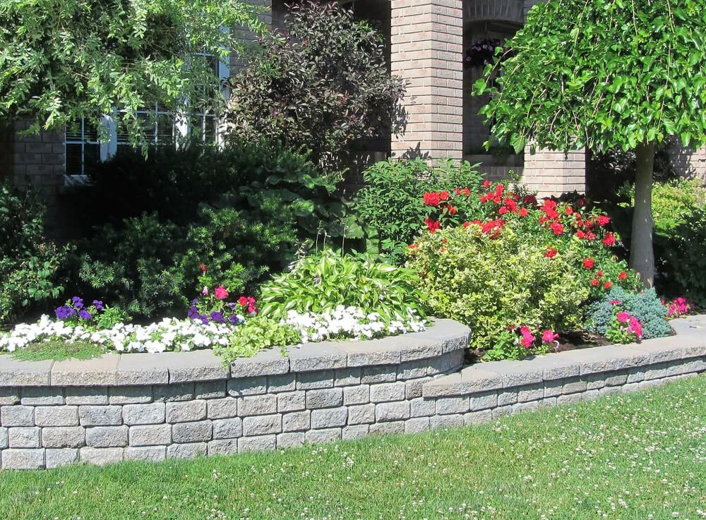 Flower bed with raised stone border edging