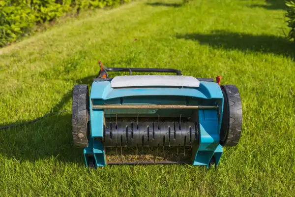 Electric lawn aerator on grass.