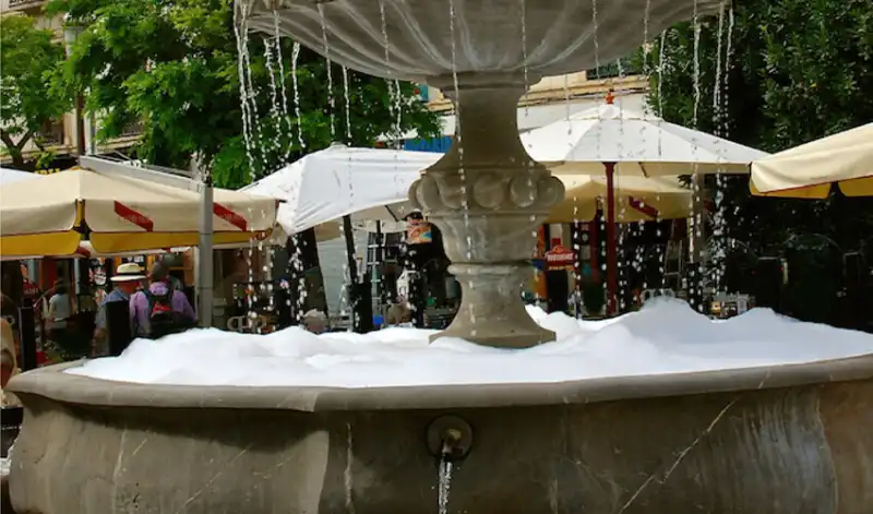 Soap suds in fountain in town square.