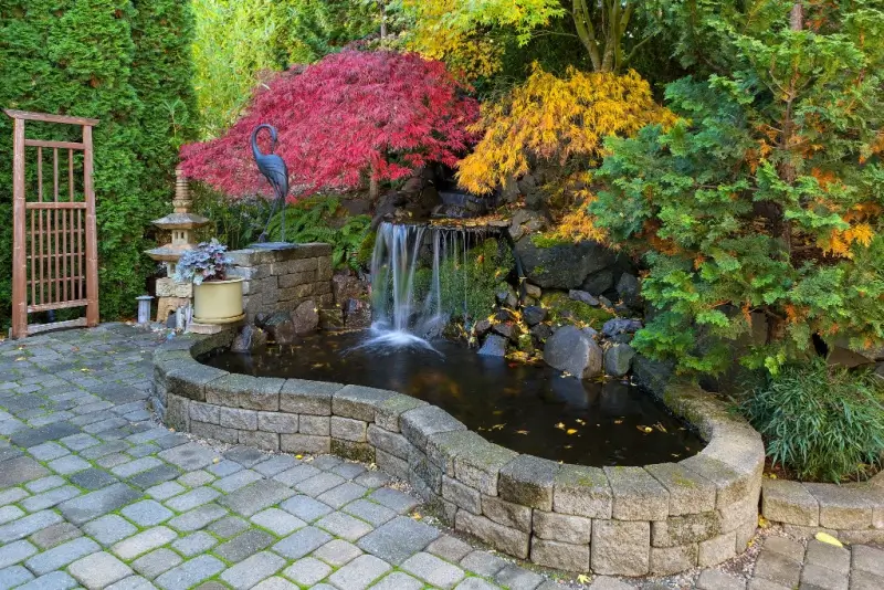 Waterfall and pond with stone border.
