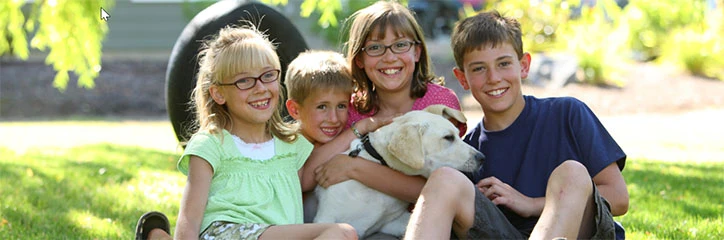 Children with dog in backyard