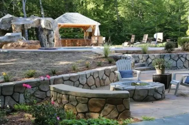 Outdoor landscaping with stonework walls and firepit