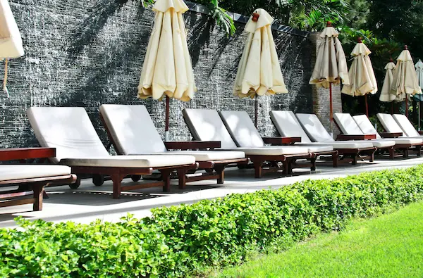 Hotel garden with row of patio furniture.