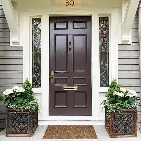 Two box planters on either side of a front door