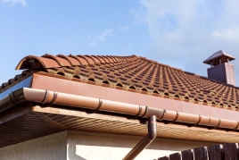 Tiled roof with gutter installed.
