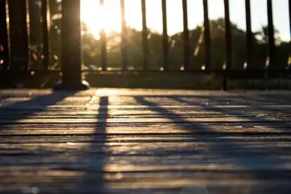 Sunset shining on a wooden deck