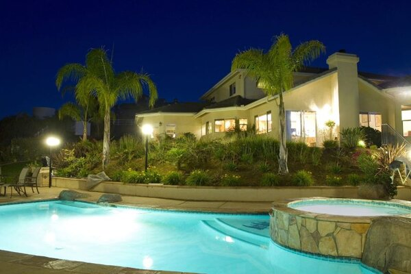 House backyard with landscape lighting installed by The Grounds Guys.