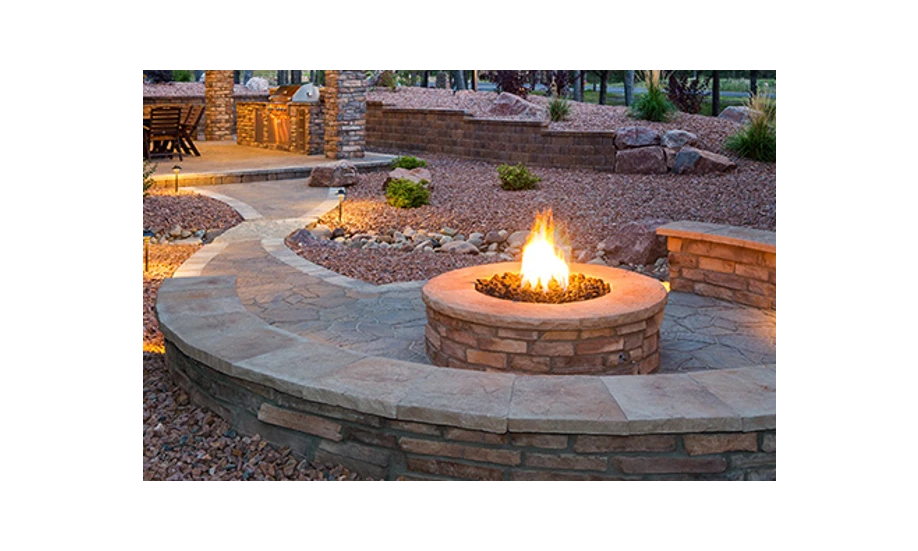 Lit stonework fire pit with built-in wrap-around bench.